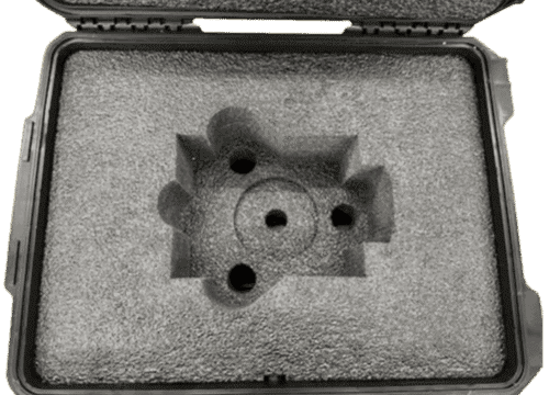 An open hard case with shaped foam supporting a nuclear defense component